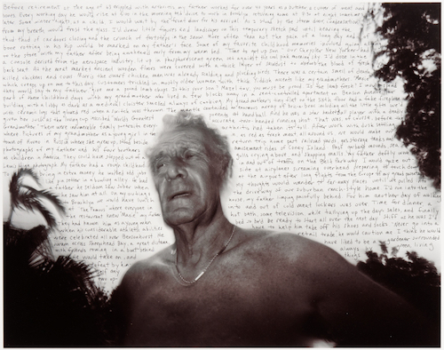 Half-length portrait of an older, light-skinned man seen against a white sky filled with handprinted text in black ink. He is bare chested and wears a gold chain. Silhouetted tropical foliage is found on the right side and bottom edge.