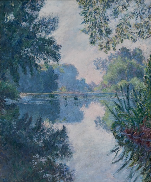 A view looking down the Seine, shadowed by dark green and blue foliage in the foreground, which opens into clear, light blue and gray sky in the background, set against the silhouette of the distant wooded riverbank. Foreground and background elements converge in their reflection on the surface of the water, which gives the effect of a mirrored composition cut at center by the horizontal far-edge of the riverbank.