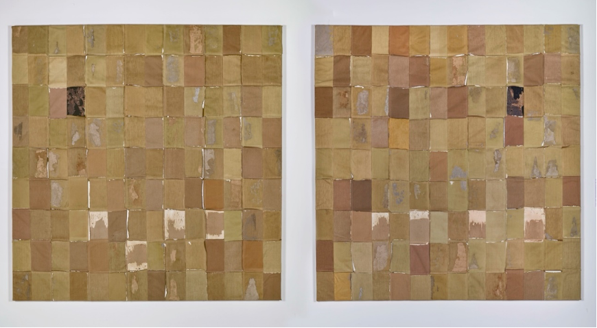Two large square panels are set side by side. Each panel is made up of 126 cloth book covers in different shades of brown and black, arranged in rows and columns to form a grid. Some of the covers are much more worn and damaged than others.
