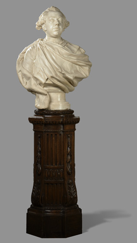 A bust of the head and shoulders of a man, with a cloth wrapped across his chest like a toga, and short hair that is curled above his ears.
