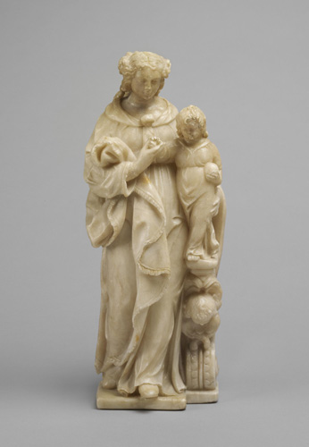 An off-white carving shows a woman in a long, loose dress holding a very young child against her with one arm. She holds a length of cloth draped over her other arm, while the child appears to be holding a ball in one hand. Both gaze downward.