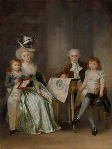A group of four light-skinned people are seated around a table looking out at the viewer. A young boy with reddish hair and a gray jacket stands next to a woman in a green striped dress with an ornate top hat on her white hair. On the other side of the table, a man with gray hair curled over his ears holds a pen in one hand and a young child with reddish hair on his lap with the other.