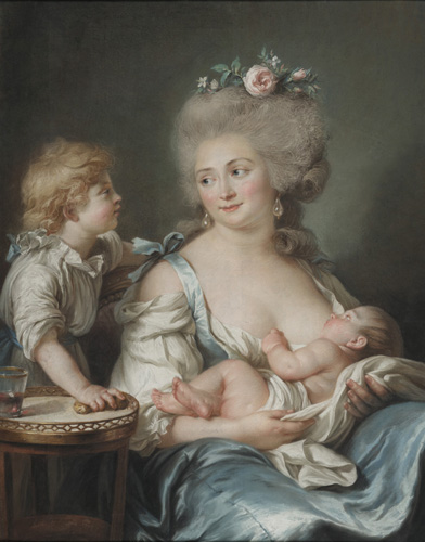 A woman with very light skin, gray hair with a few curls that has been pulled into an updo with roses, and a shiny blue dress is seated, the top of her dress pulled down to allow an infant in her arms to breastfeed. The woman is turned to face another young child with light skin and blonde hair, who stands alongside her looking into her face with one arm on the back of her chair.