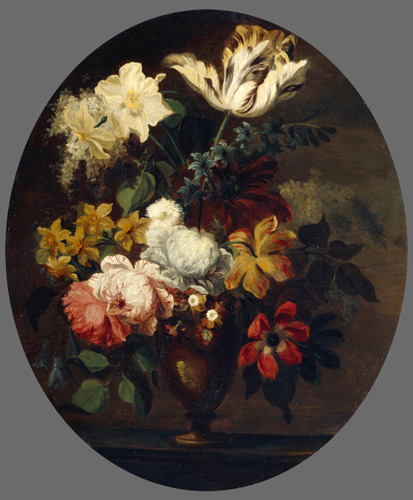 A vase of flowers, including daffodils and irises, is shown. The flowers are different shapes and sizes, and their colors are reds, yellows, and whites.